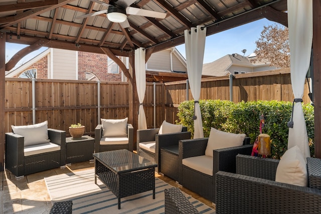 view of patio / terrace with fence, an outdoor living space, a ceiling fan, and a gazebo