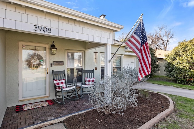 entrance to property featuring stucco siding