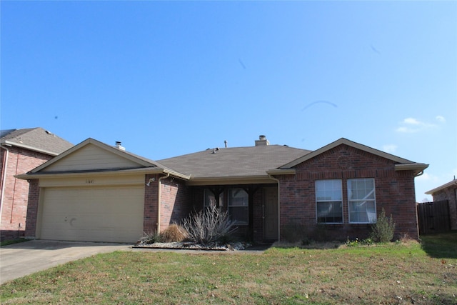 single story home with a front yard, brick siding, driveway, and an attached garage