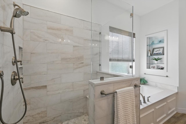 bathroom with walk in shower and a garden tub