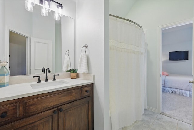 bathroom with tile patterned flooring, connected bathroom, and vanity