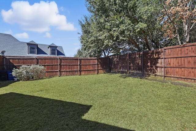 view of yard with a fenced backyard