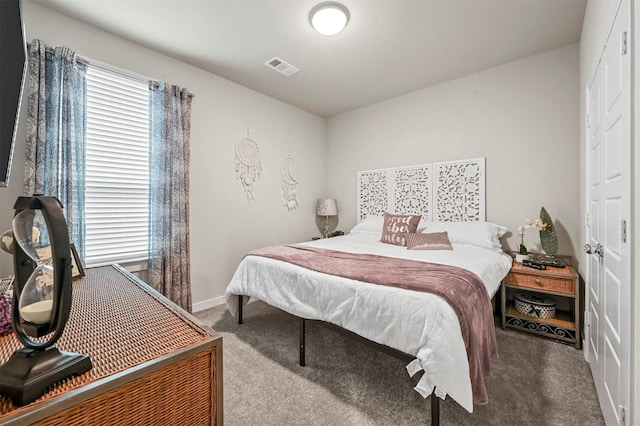 bedroom with carpet, visible vents, and baseboards