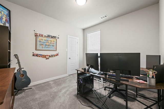 carpeted office space featuring visible vents and baseboards