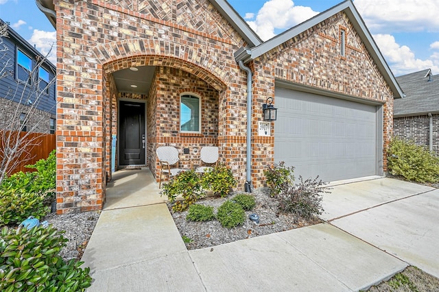 view of front of house featuring brick siding, covered porch, an attached garage, fence, and driveway