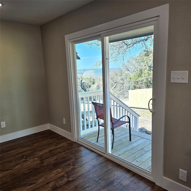 doorway with a healthy amount of sunlight, baseboards, and dark wood finished floors