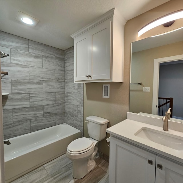 bathroom featuring shower / bathing tub combination, vanity, and toilet