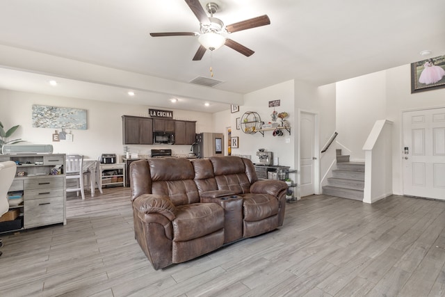 living area with ceiling fan, recessed lighting, visible vents, light wood-style floors, and stairs