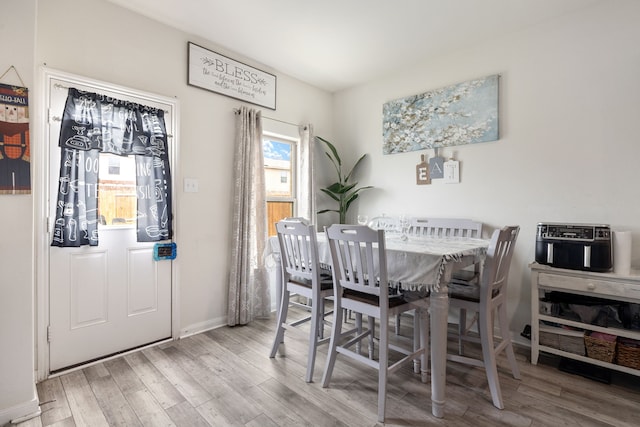 dining room with wood finished floors and baseboards