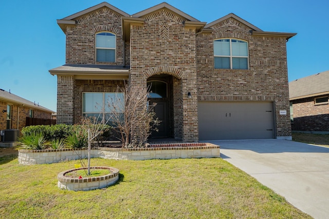 view of front facade featuring an attached garage, cooling unit, brick siding, driveway, and a front yard