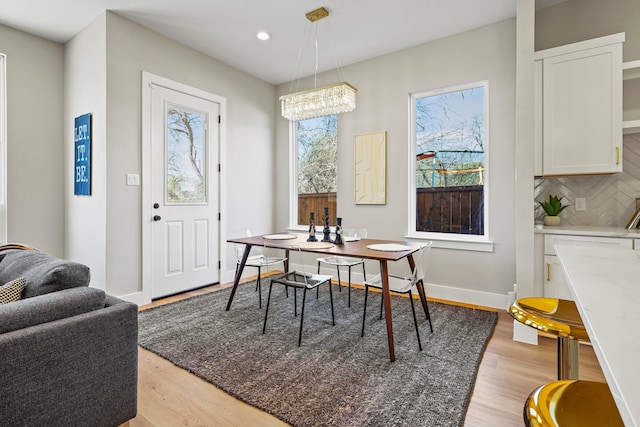 dining area featuring recessed lighting, baseboards, and light wood finished floors