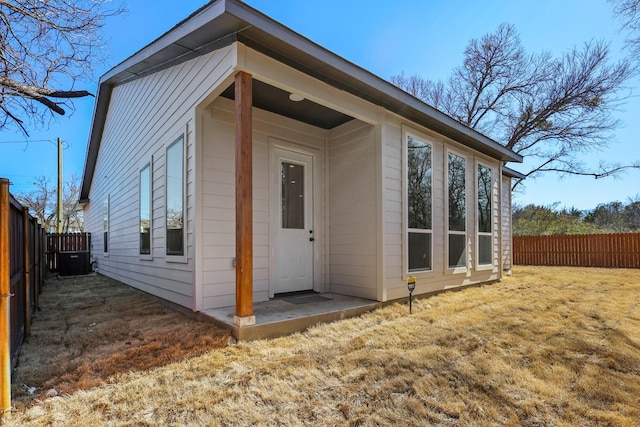 view of outbuilding featuring cooling unit and a fenced backyard