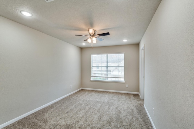 carpeted empty room with a textured ceiling, a textured wall, recessed lighting, a ceiling fan, and baseboards