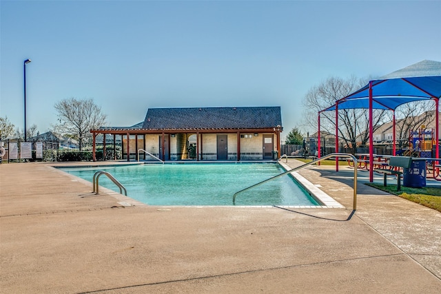 community pool with fence and a patio