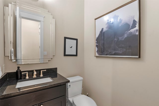 bathroom featuring toilet and vanity