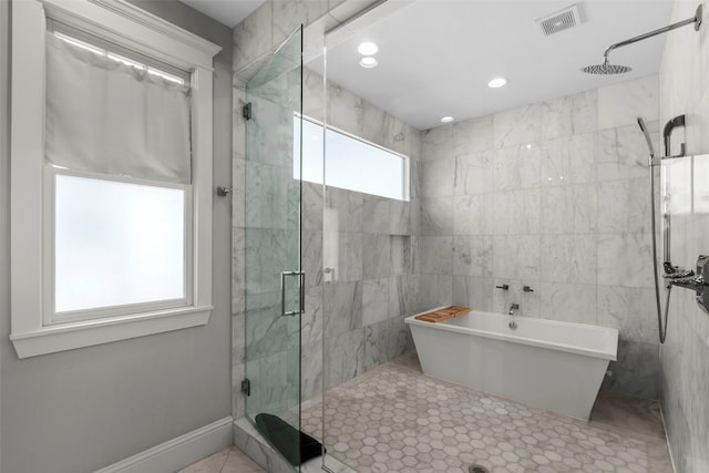 full bath featuring recessed lighting, a soaking tub, visible vents, a stall shower, and baseboards