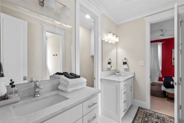 bathroom featuring a sink, ensuite bath, crown molding, and two vanities