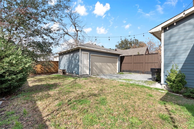 view of yard featuring a garage, an outdoor structure, and a fenced backyard