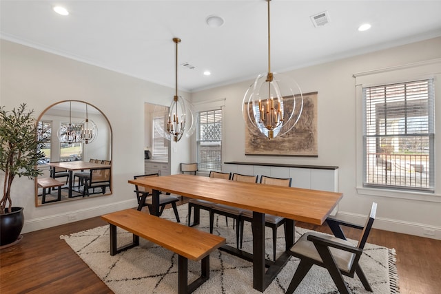 dining space with a chandelier, visible vents, dark wood finished floors, and baseboards