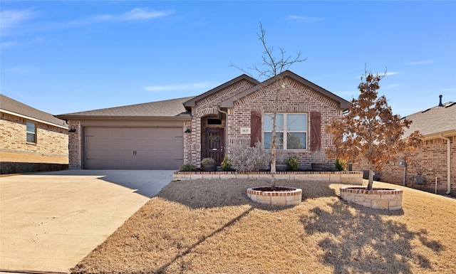 single story home with driveway, an attached garage, and brick siding