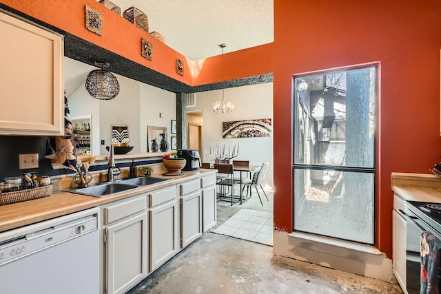 kitchen featuring a sink, white cabinetry, light countertops, dishwasher, and decorative light fixtures