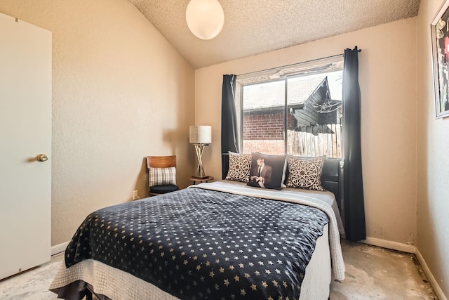 bedroom with lofted ceiling, a textured wall, a textured ceiling, and baseboards