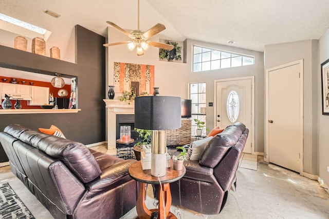 4727 Poppy Dr E, Fort Worth, TX 76137 - living room featuring a glass covered fireplace, ceiling fan, and high vaulted ceiling