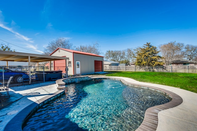 view of pool with a hot tub, a fenced backyard, an outbuilding, a yard, and a patio area