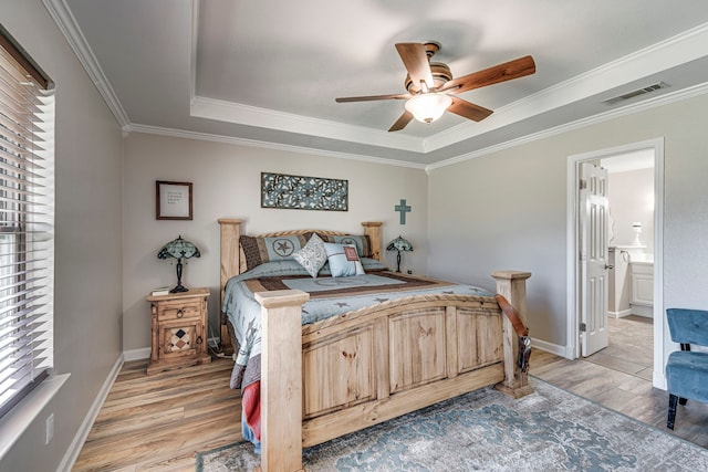 bedroom with visible vents, baseboards, a ceiling fan, ornamental molding, and light wood finished floors