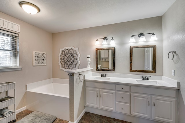 full bath with a garden tub, a sink, and double vanity