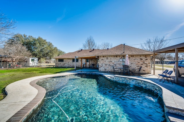 view of pool featuring a yard, a patio area, fence, and a fenced in pool