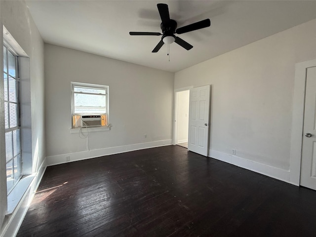 spare room with a ceiling fan, baseboards, dark wood finished floors, and cooling unit