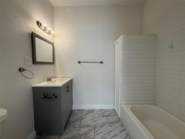 full bathroom with toilet, vanity, baseboards, marble finish floor, and shower / washtub combination