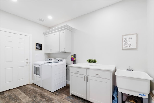 laundry area featuring cabinet space, visible vents, dark wood finished floors, washing machine and dryer, and recessed lighting