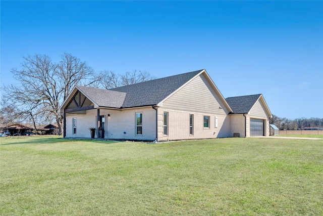 view of property exterior with a shingled roof, brick siding, a yard, and an attached garage