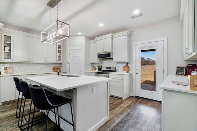 kitchen with white cabinetry, appliances with stainless steel finishes, and light countertops