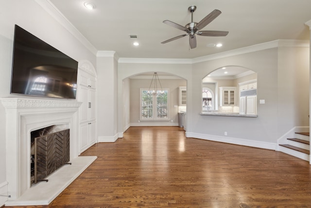 living area with dark wood-style floors, a fireplace with raised hearth, visible vents, ornamental molding, and baseboards