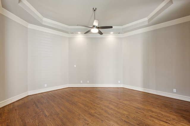 unfurnished room featuring wood finished floors, a raised ceiling, a ceiling fan, and crown molding