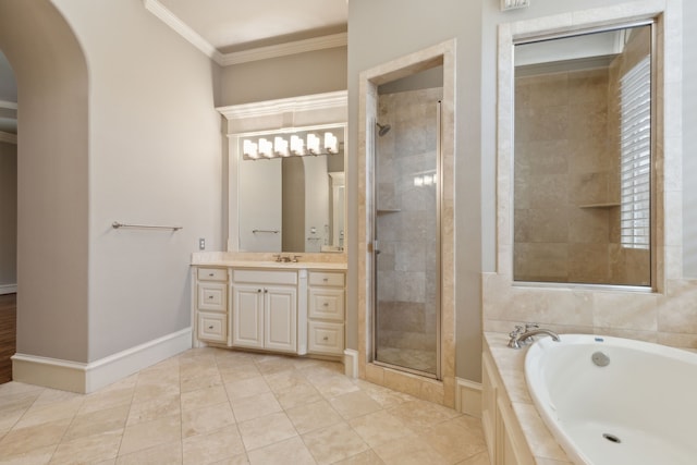 full bathroom featuring a garden tub, vanity, baseboards, ornamental molding, and a stall shower