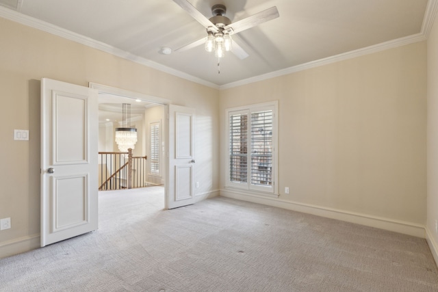 spare room with light carpet, baseboards, ornamental molding, and ceiling fan with notable chandelier