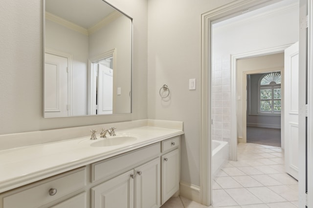 full bath featuring ornamental molding, vanity, baseboards, and tile patterned floors