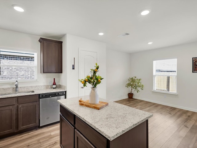 kitchen with recessed lighting, a sink, stainless steel dishwasher, light wood-type flooring, and a center island