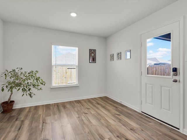 interior space with light wood finished floors and baseboards