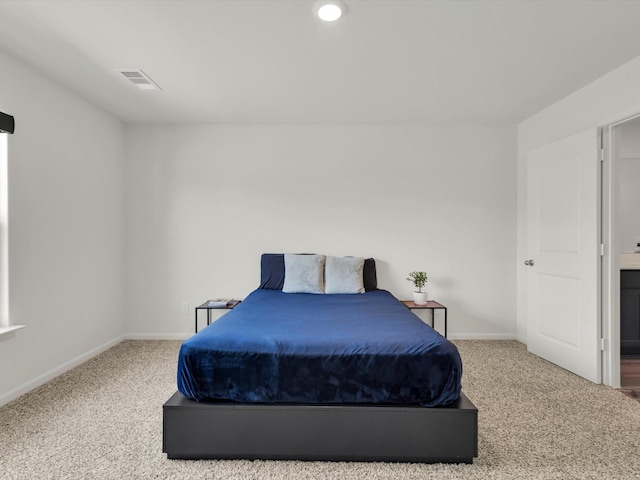 bedroom with carpet floors, baseboards, and visible vents