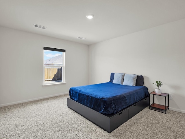 carpeted bedroom featuring visible vents and baseboards