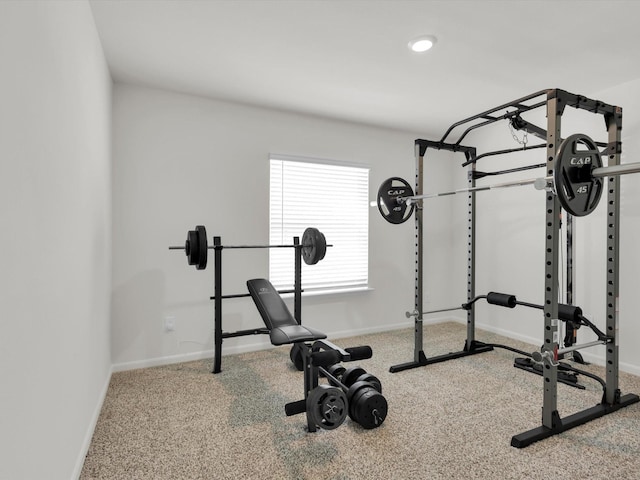 exercise area with baseboards and carpet flooring