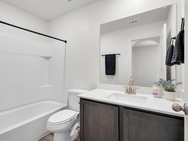 bathroom featuring visible vents, shower / washtub combination, vanity, and toilet