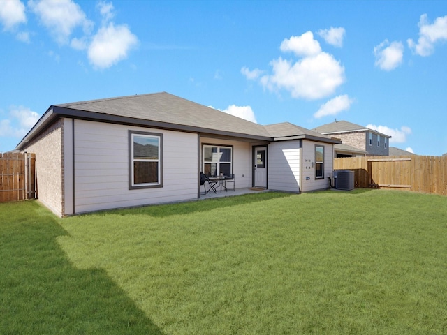 back of property featuring a yard, a fenced backyard, a patio area, and cooling unit