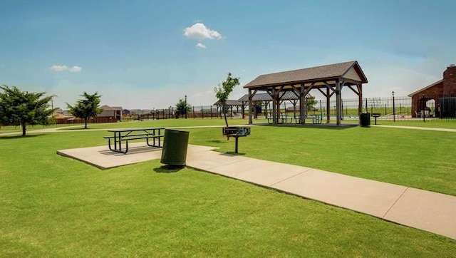 view of property's community with a lawn and a gazebo