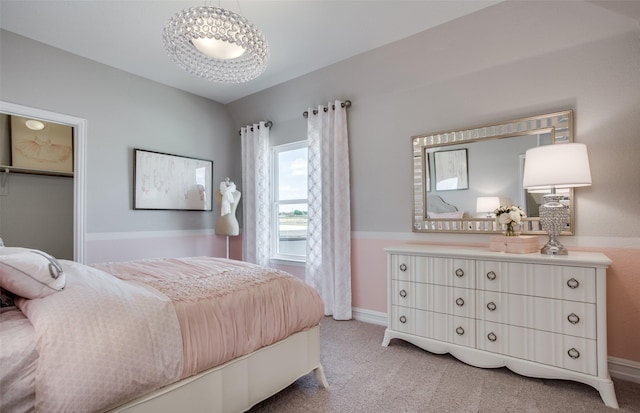 bedroom featuring light carpet and baseboards